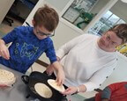 a woman and a young boy working together