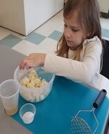 A young girl working on a craft