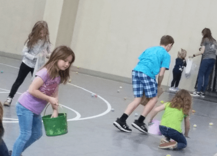 A group of children hunting for easter eggs