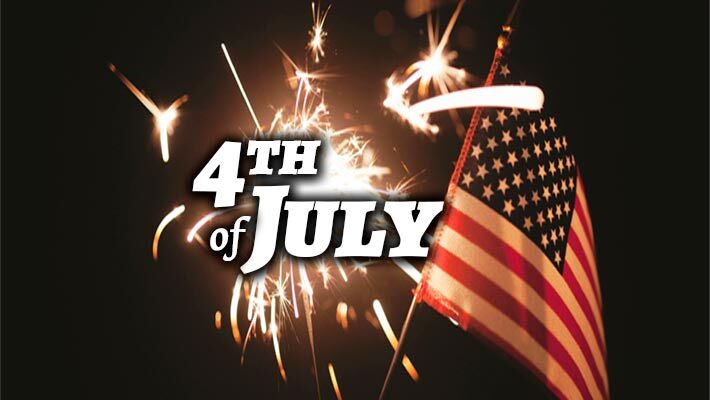 4th of July. A sparkler is being held in a hand with a small American flag.