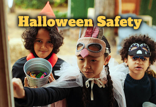 Halloween Safety. Three children in costumes are knocking at a door to trick-or-treat.