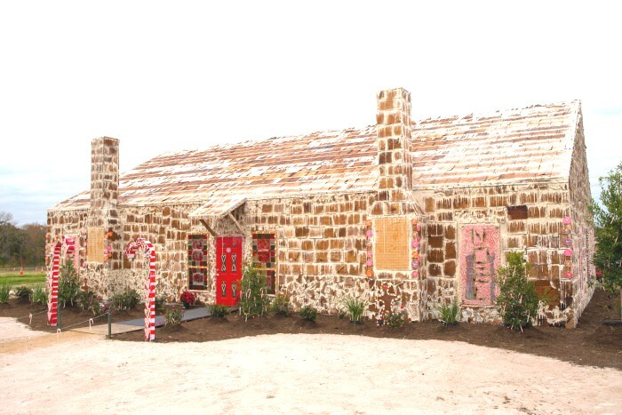 The worlds largest gingerbread house is covered in icing and candy.