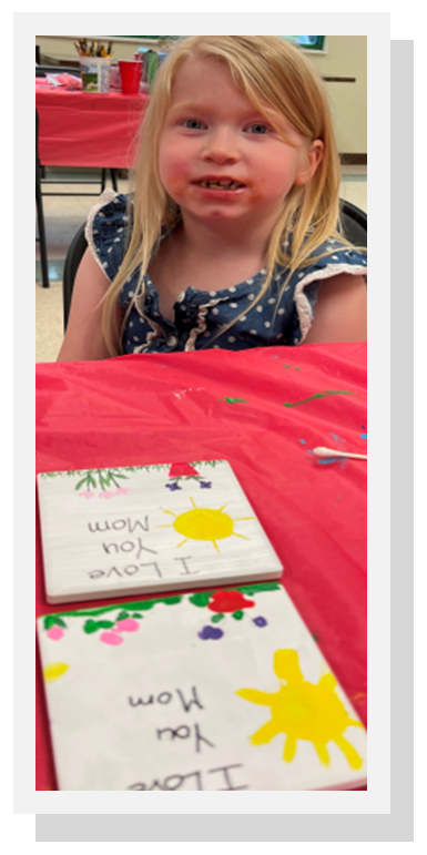 Girl showing off painted crafts